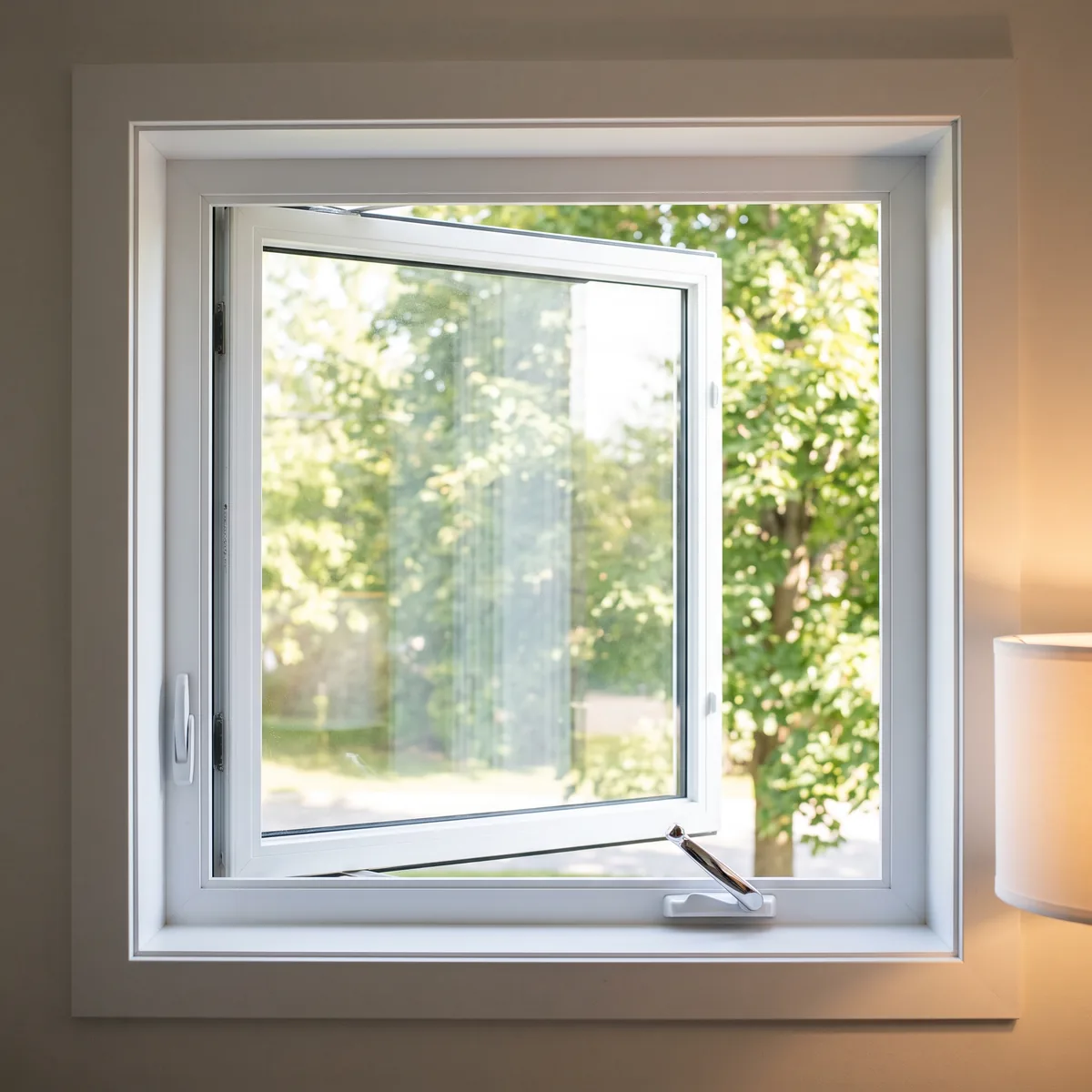 White PVC casement window cranked open outward, crank handle clearly visible